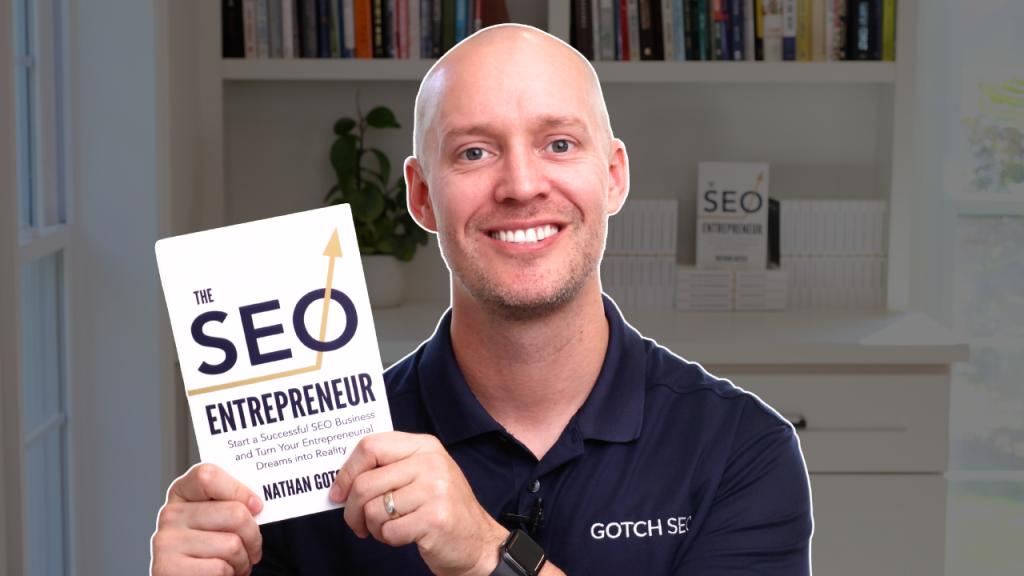 Nathan Gotch holding The SEO Entrepreneur book